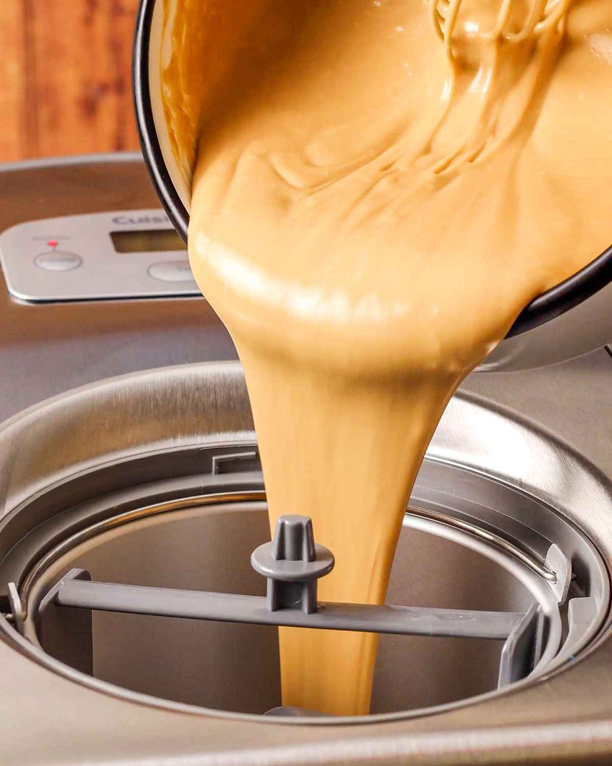 pouring the biscoff ice cream mixture into the Cuisinart Ice Cream Maker