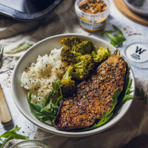 vegan miso aubergine roasted on a serving plate, served with rice and broccoli