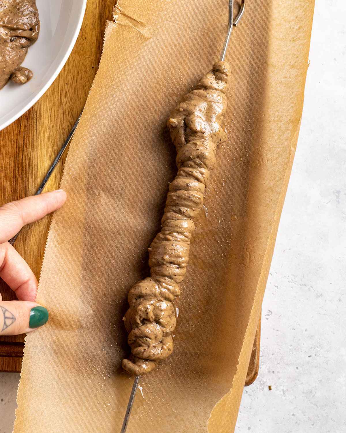 twirled seitan kabob about to be wrapped in parchment