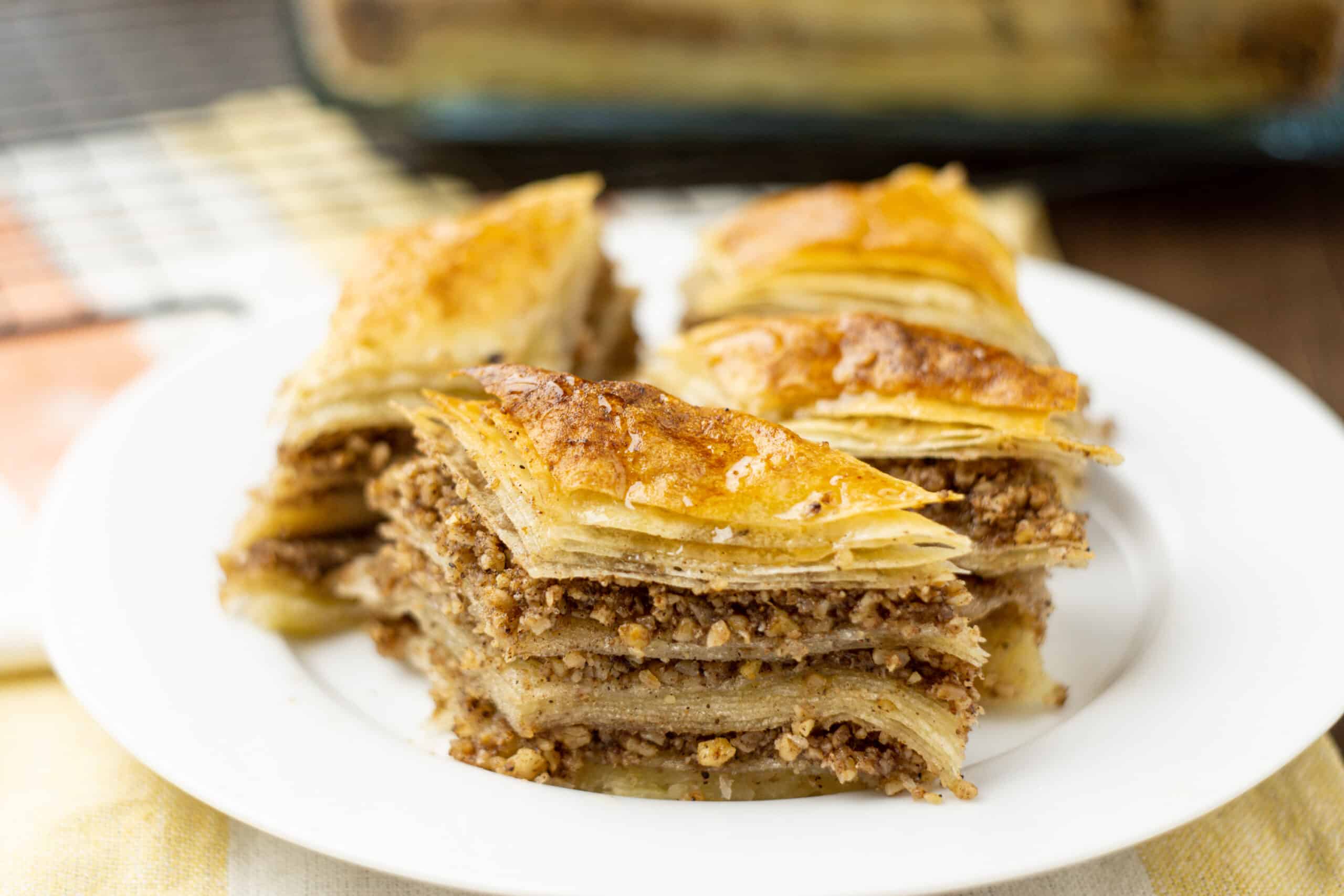 4 pieces of vegan baklava on a white plate