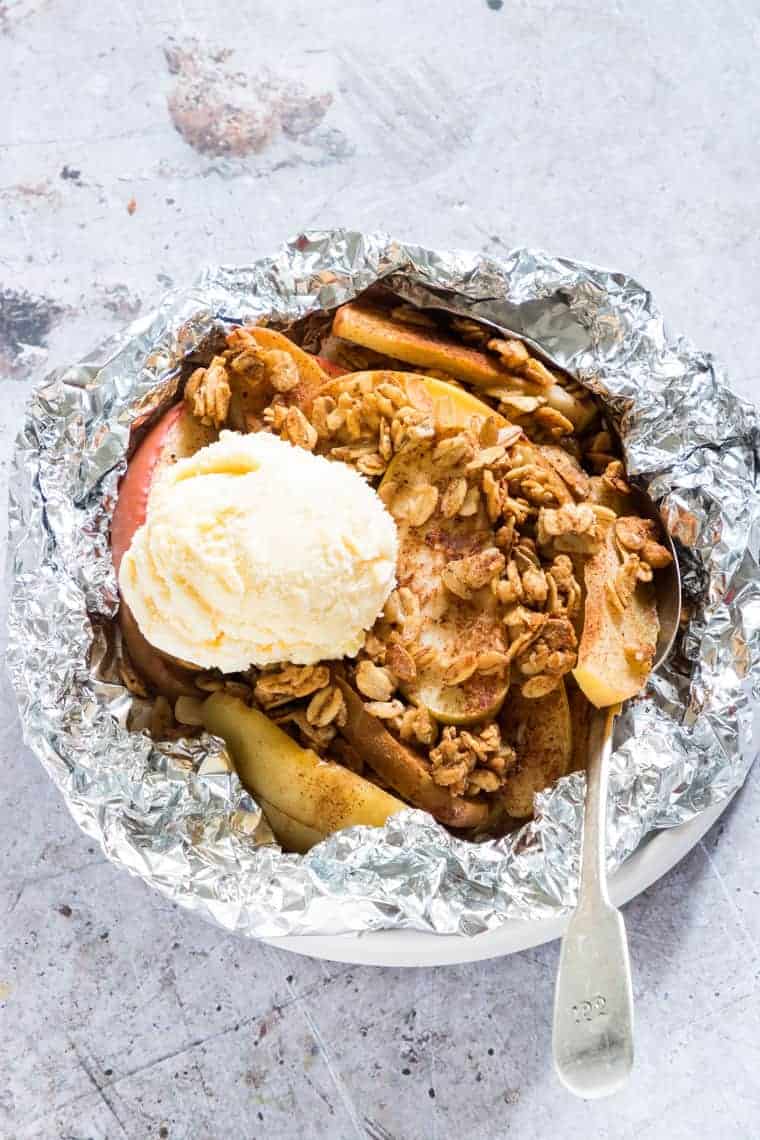 vegan apple crisp is a package made of foil with a dollop of vegan ice cream on top