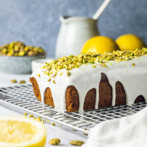 vegan pistachio loaf cake with cardamom and white icing on top