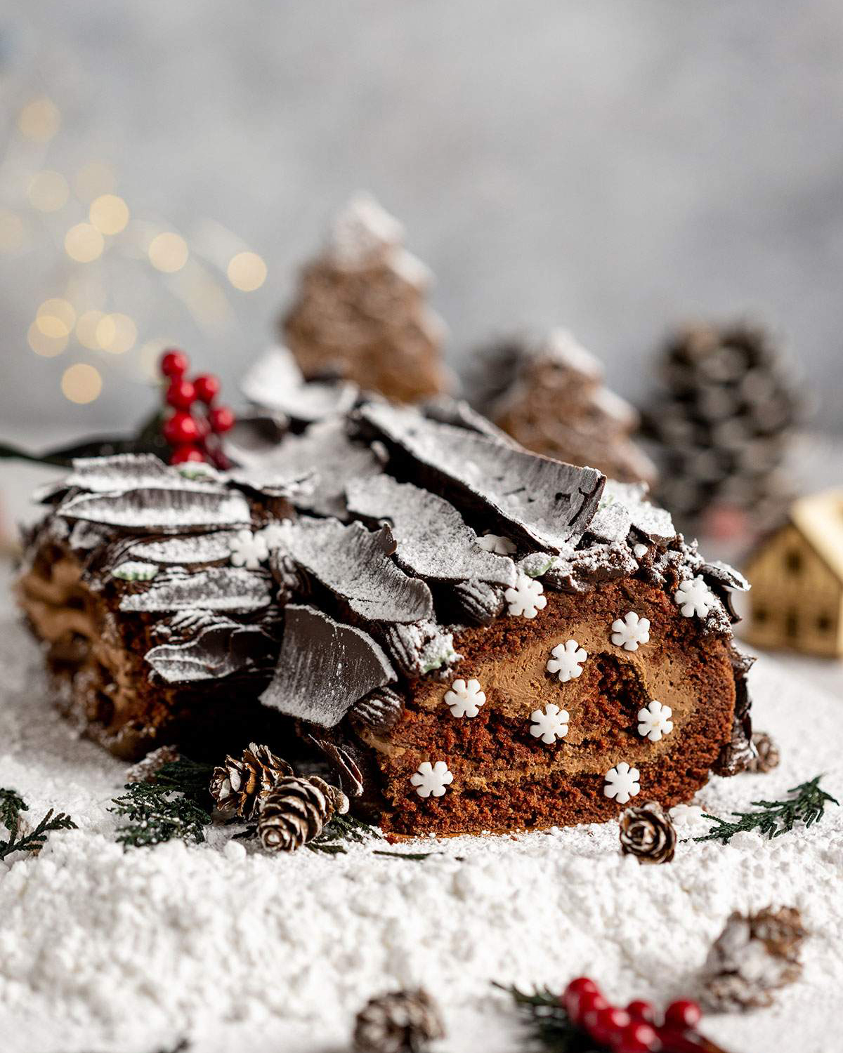 Vegan Yule Log with Chocolate bark sprinkled in icing sugar