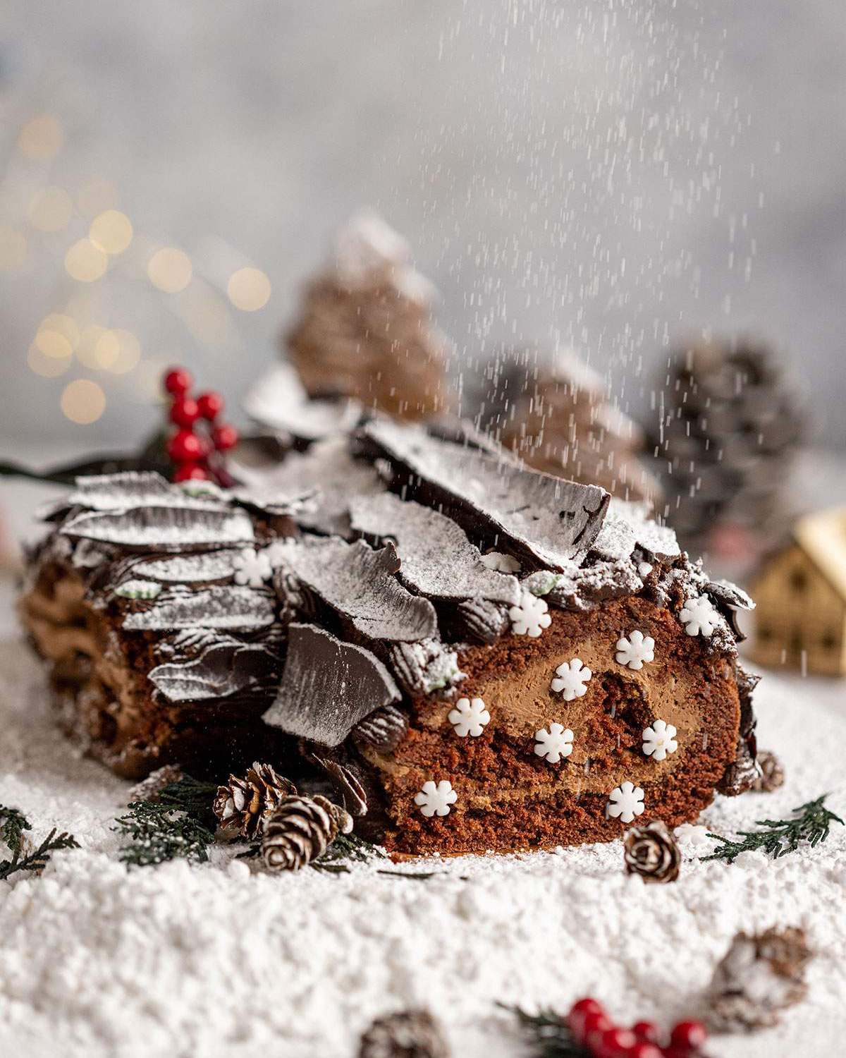 Vegan Yule Log with Chocolate bark sprinkled in icing sugar