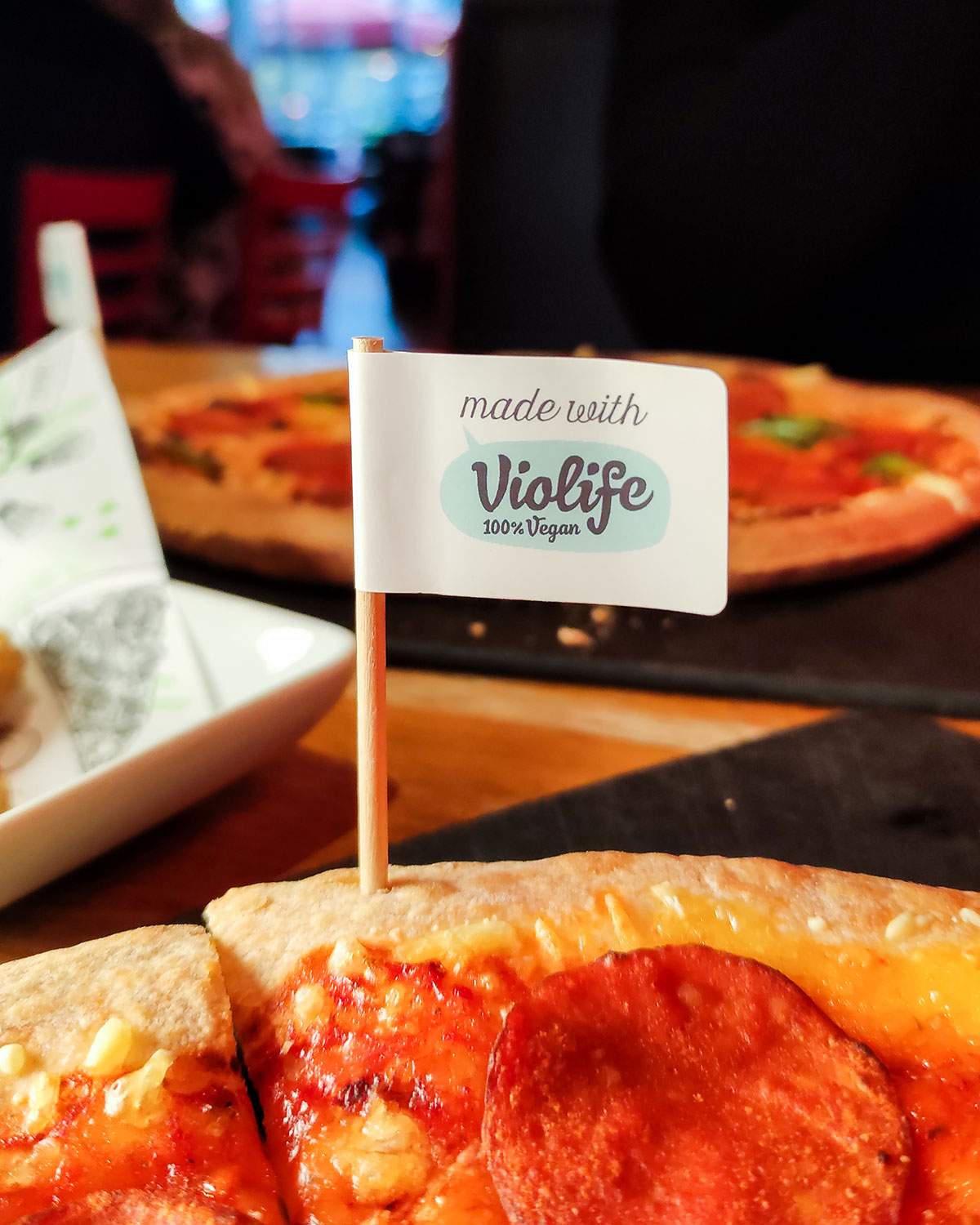 violife flag in the pizza crust of a vegan pizza at pizza hut