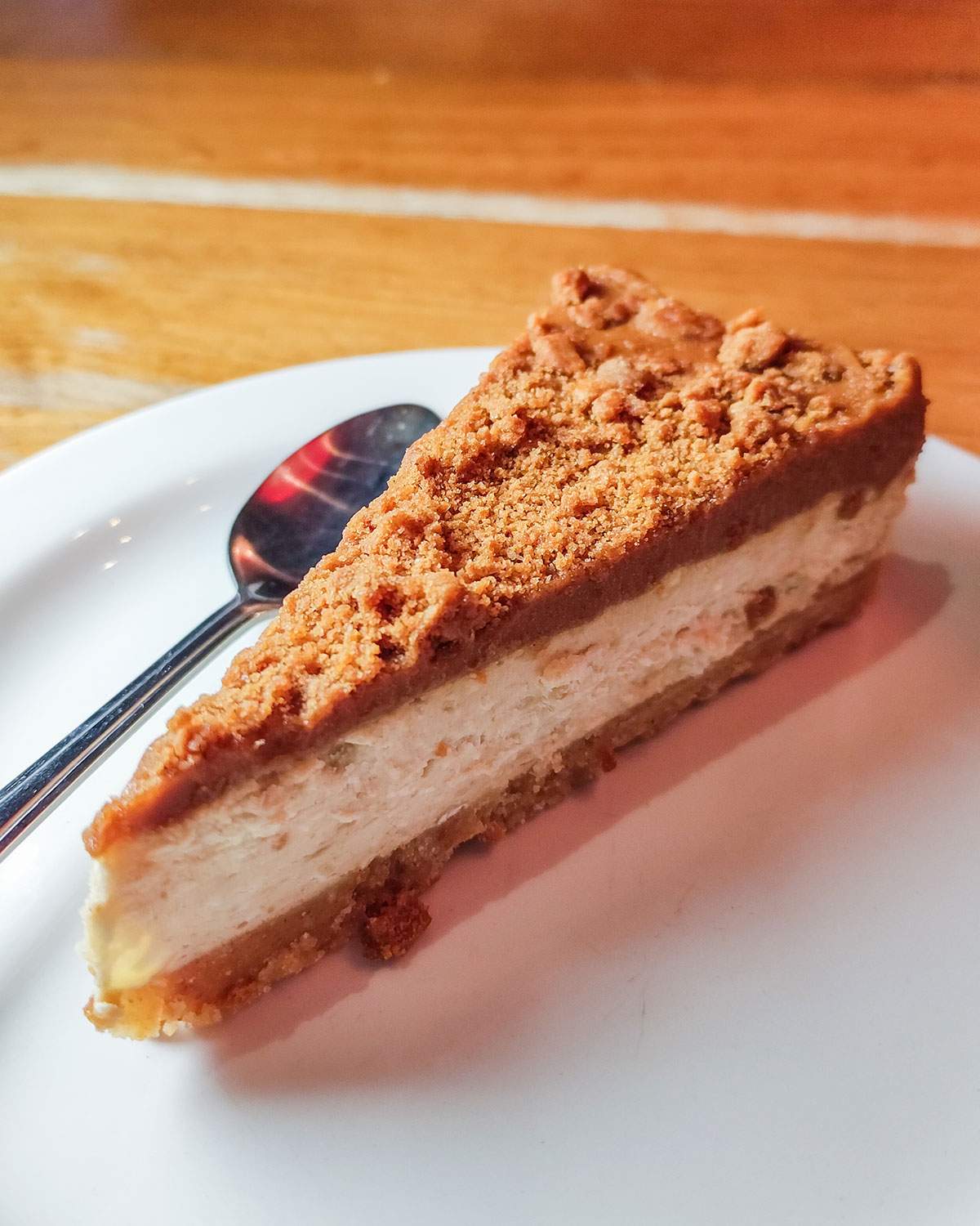 a slice of vegan cheesecake dessert at pizza hut on a white plate