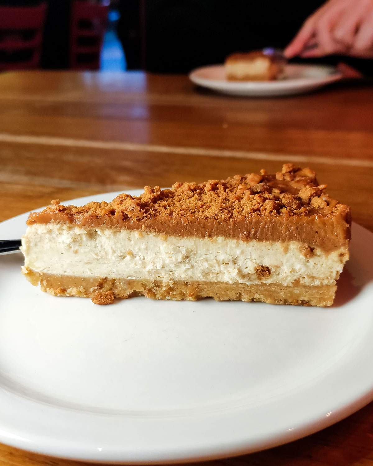 a slice of vegan cheesecake dessert at pizza hut on a white plate