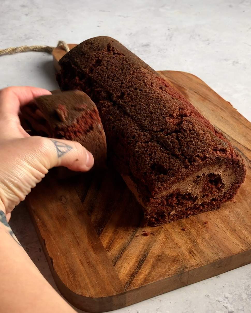 placing swiss roll end piece onto the side of the vegan yule log