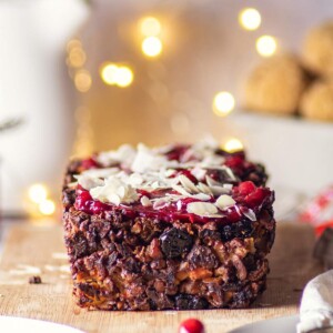 vegan apple nut roast on a wooden board with fairylights in the background