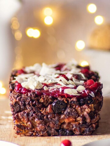 vegan apple nut roast on a wooden board with fairylights in the background