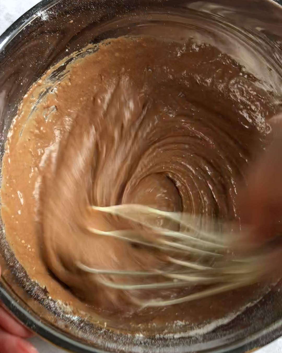 whisking vegan chocolate sponge cake batter