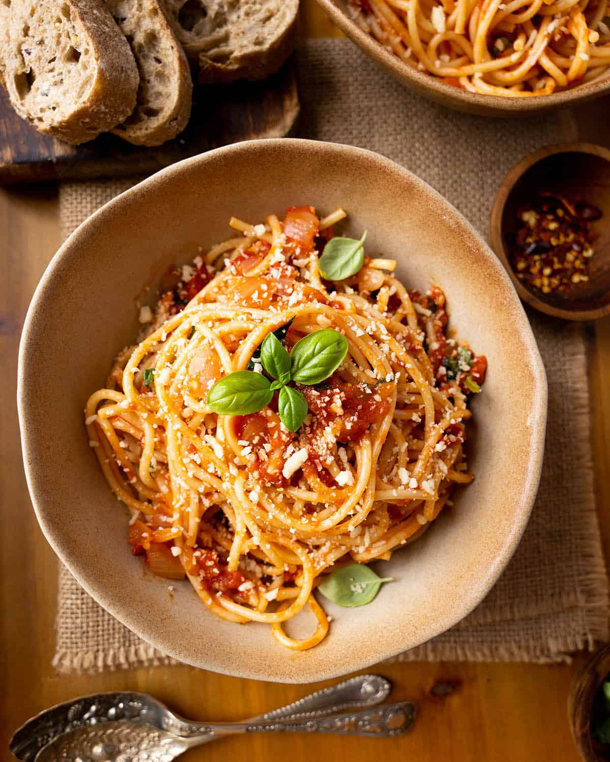 a bowl on the dinner table filled with vegan spaghetti arrabbiata
