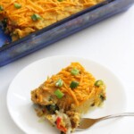 a slice of vegan breakfast casserole on a white plate with a fork