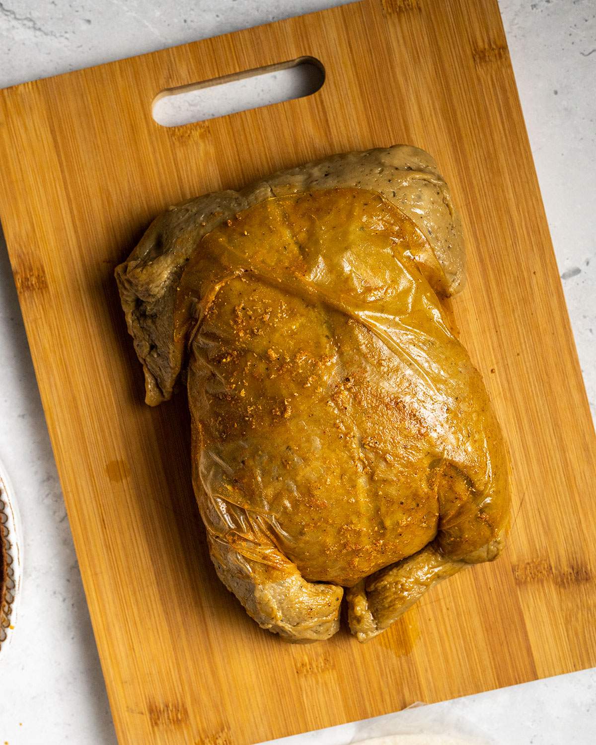 coating vegan seitan turkey in seasoned rice paper skin