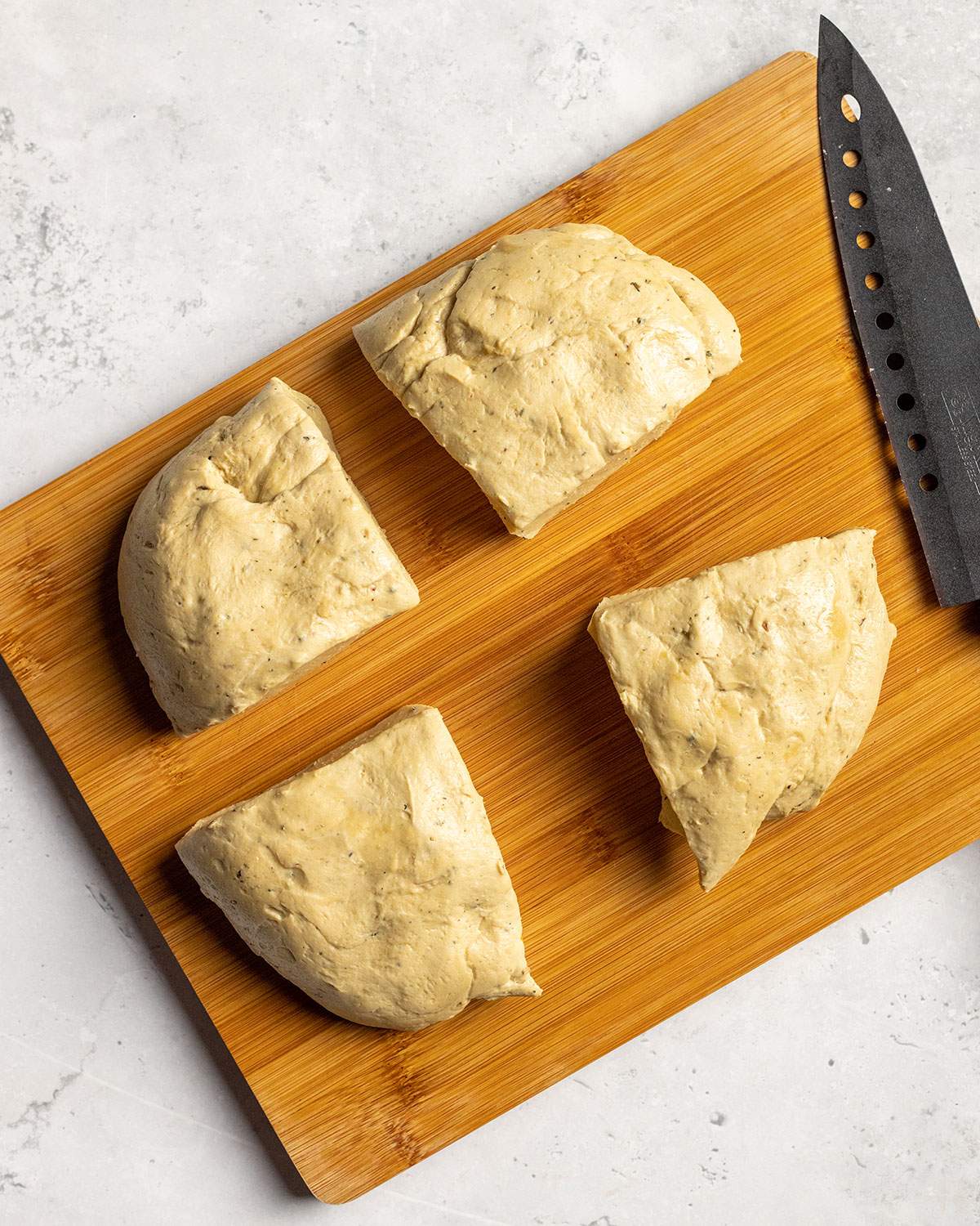 cutting vegan schnitzel dough into 4 equal pieces