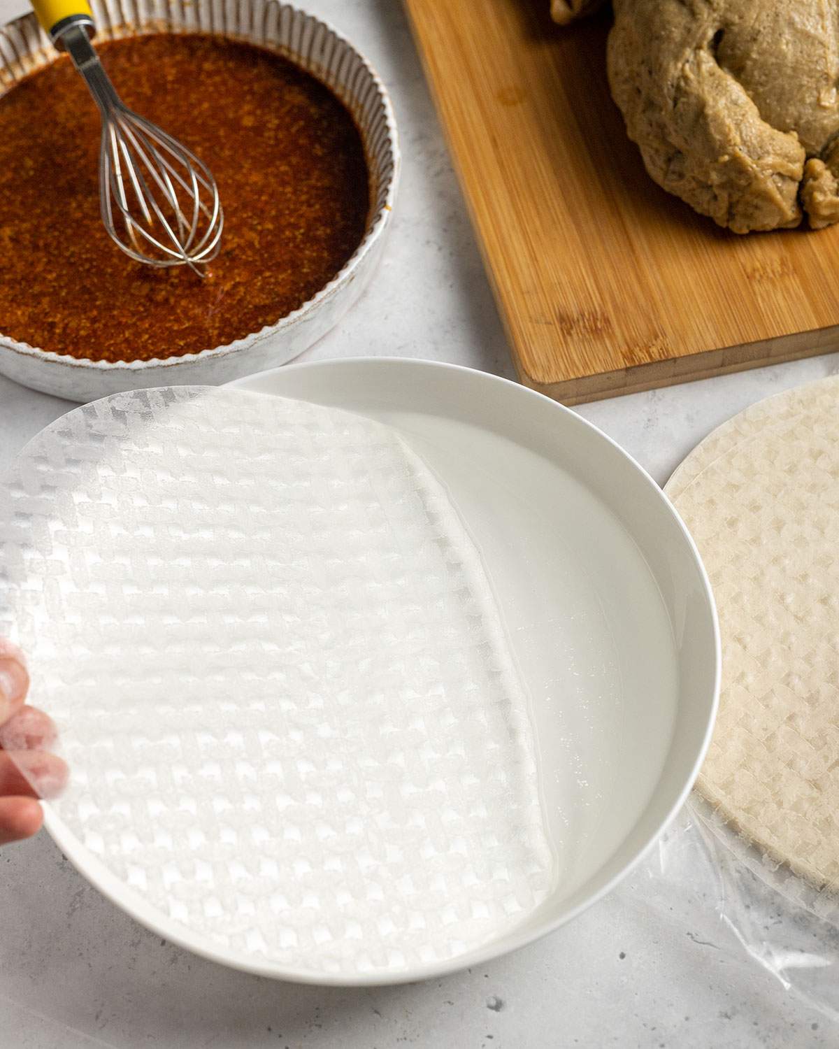 soaking rice paper in a bowl of water