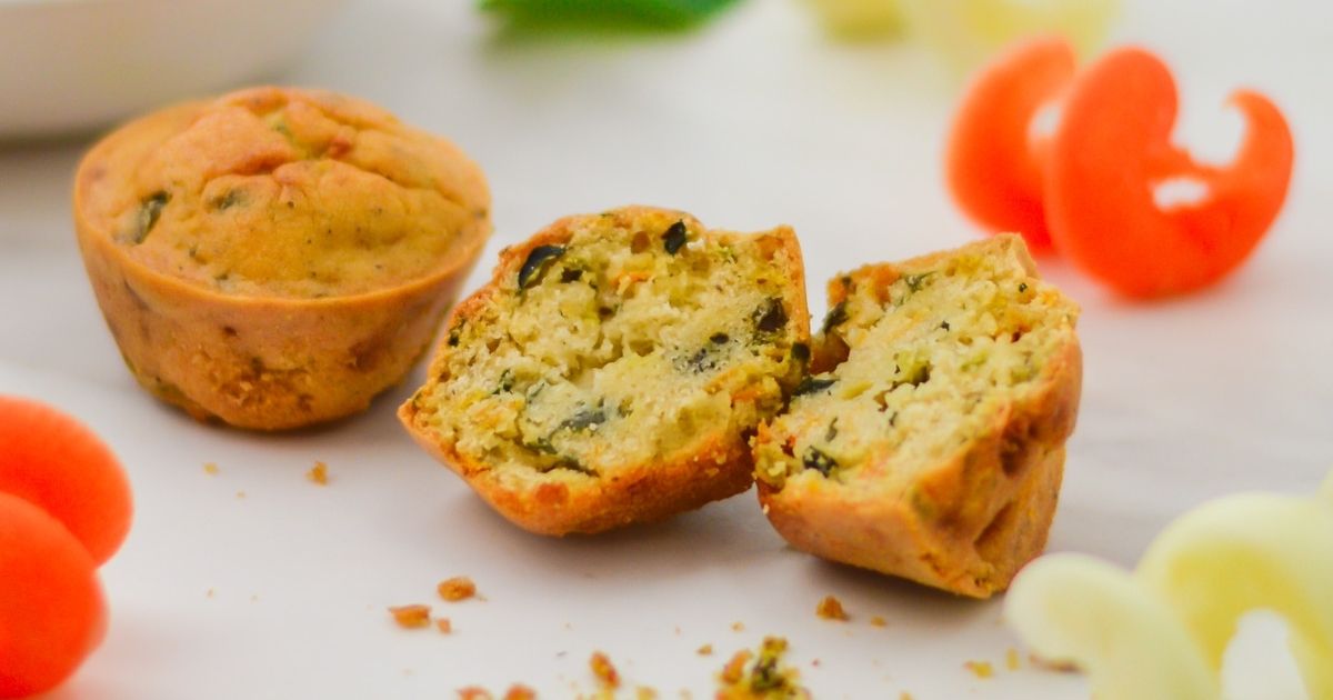 a vegan vegetable frittata cut in half on a white table