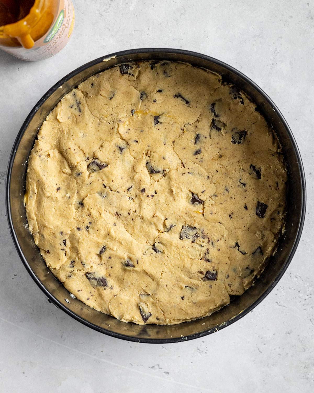 vegan chocolate chip cookie dough in a round springform pan 3