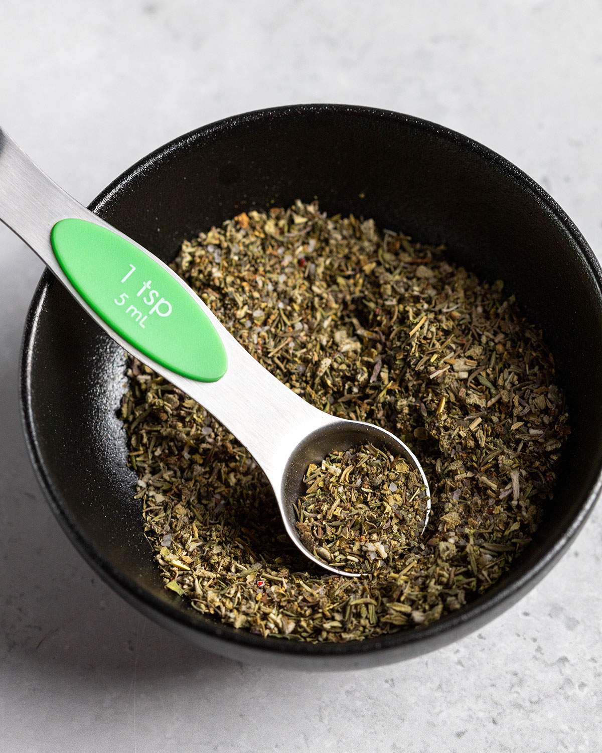 vegan poultry seasoning in a small bowl with a spoon