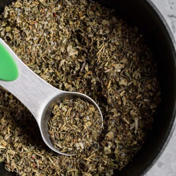 vegan poultry seasoning in a small bowl with a measuring spoon