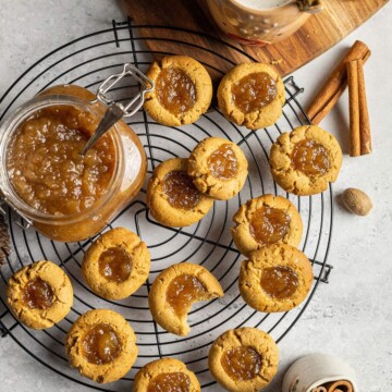 a cooling rack covered with vegan thumbprint cookies