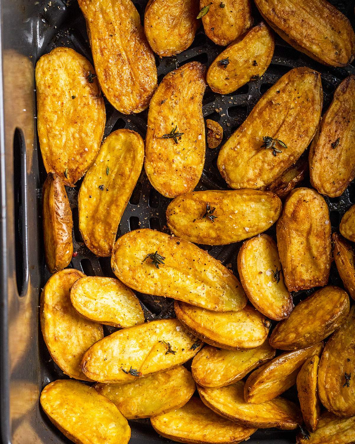 cooked fingerling potatoes in an air fryer basket