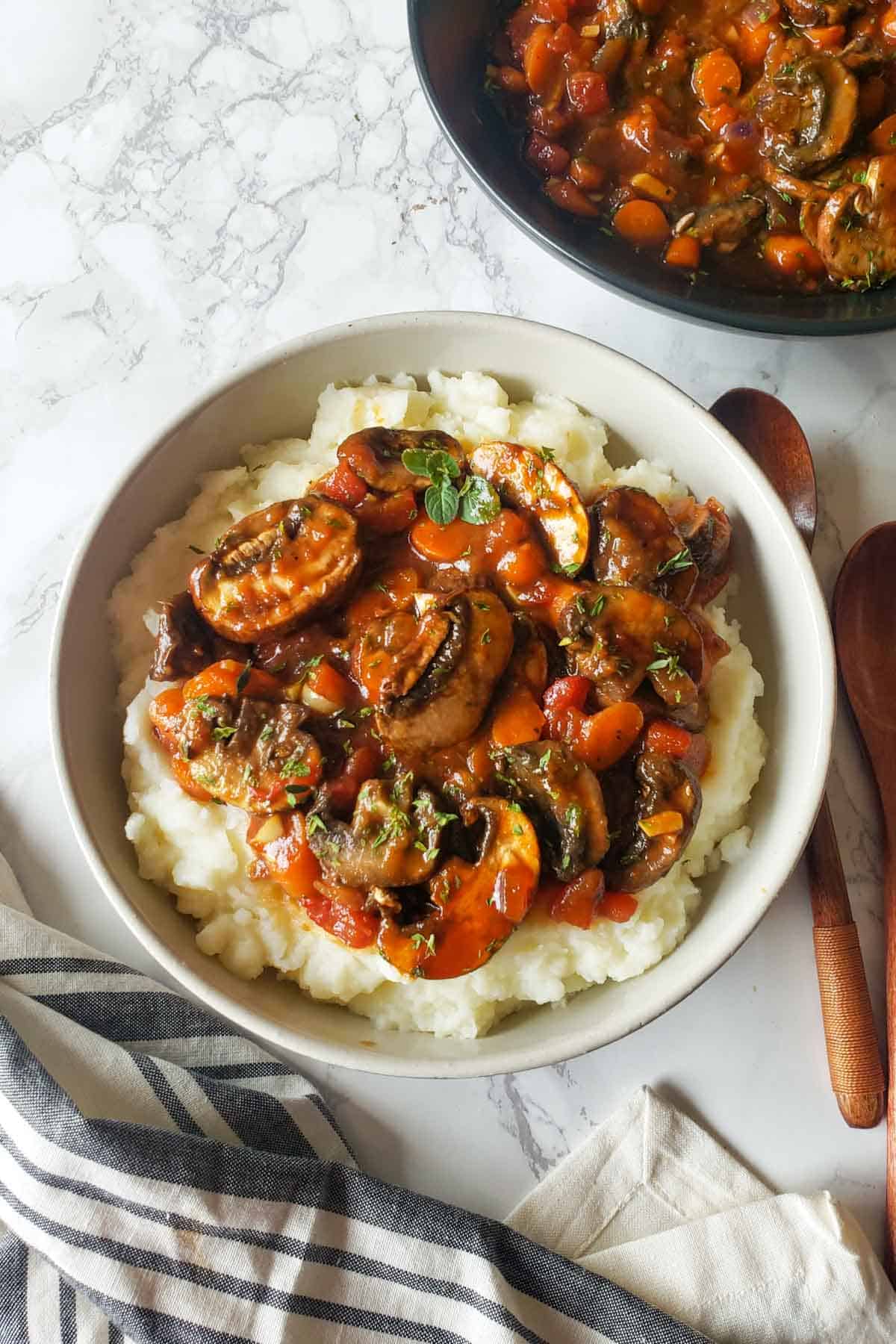 a bowl with mashed potato topped with vegan mushroom stew