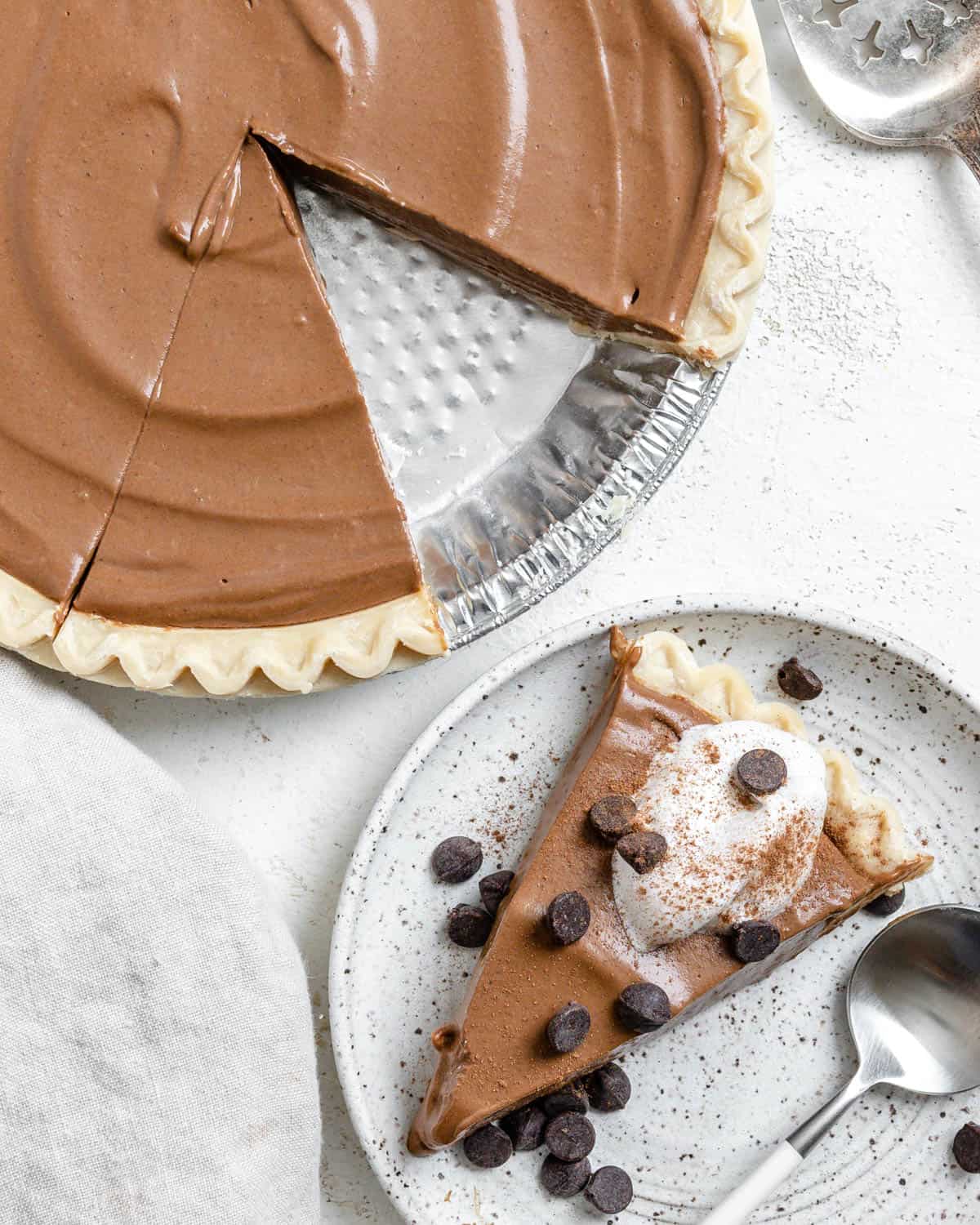 pumpkin chocolate pie with a slice cut out of it