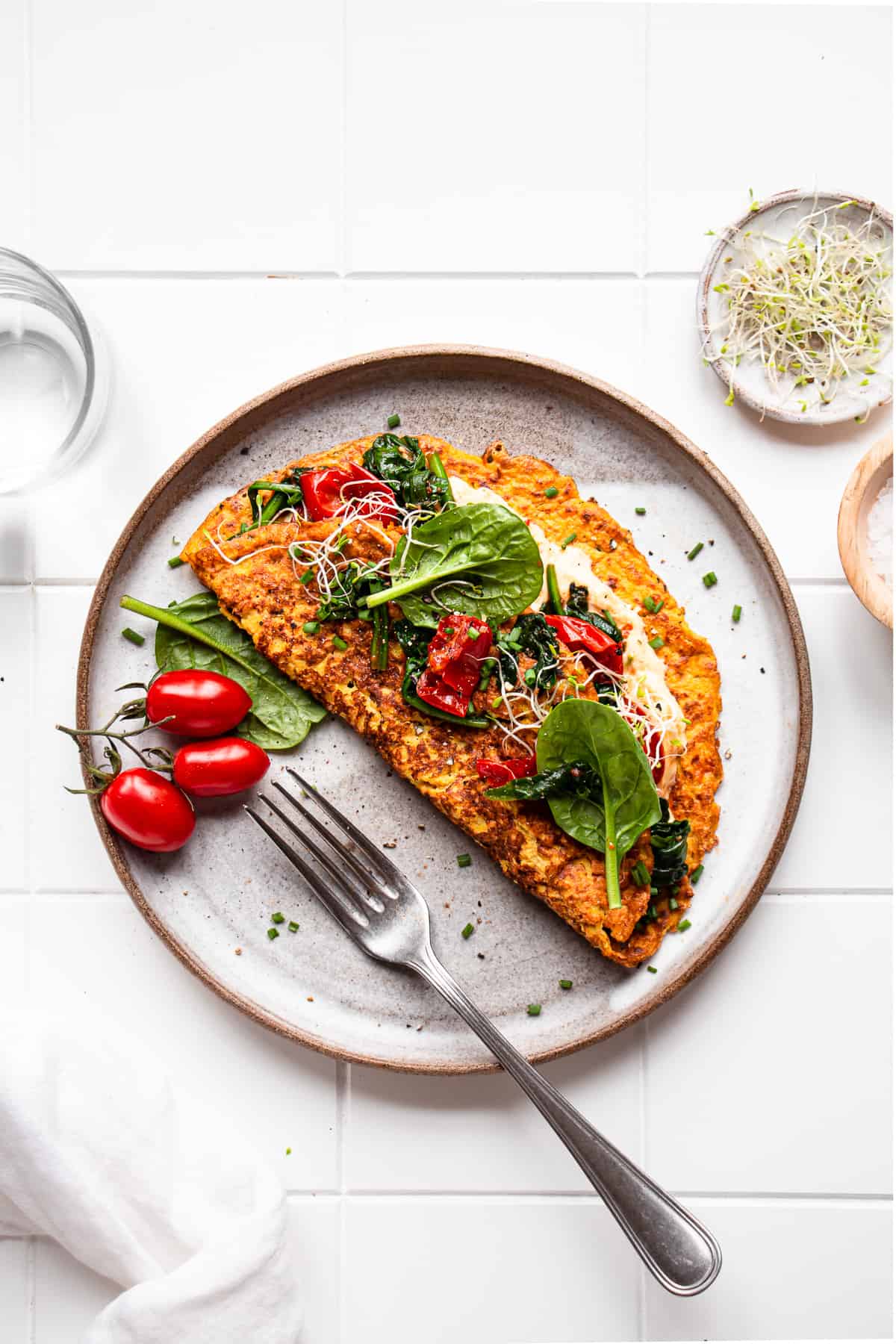 tofu omelette on a plate with a fork next to it