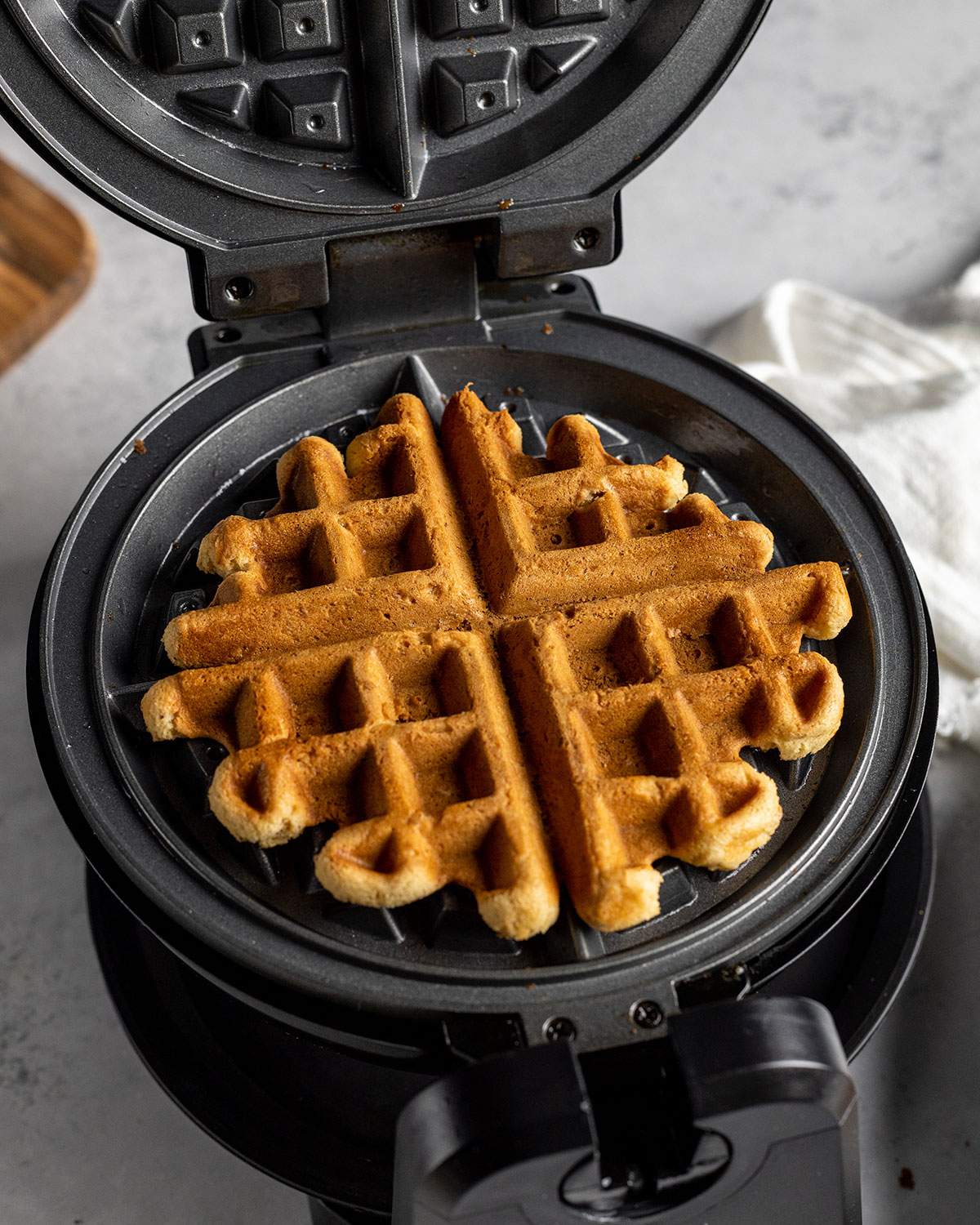 a cooked waffle in an open waffle maker