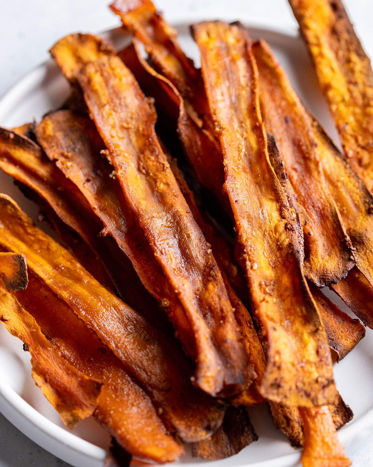 Carrot bacon strips sitting in a bowl.