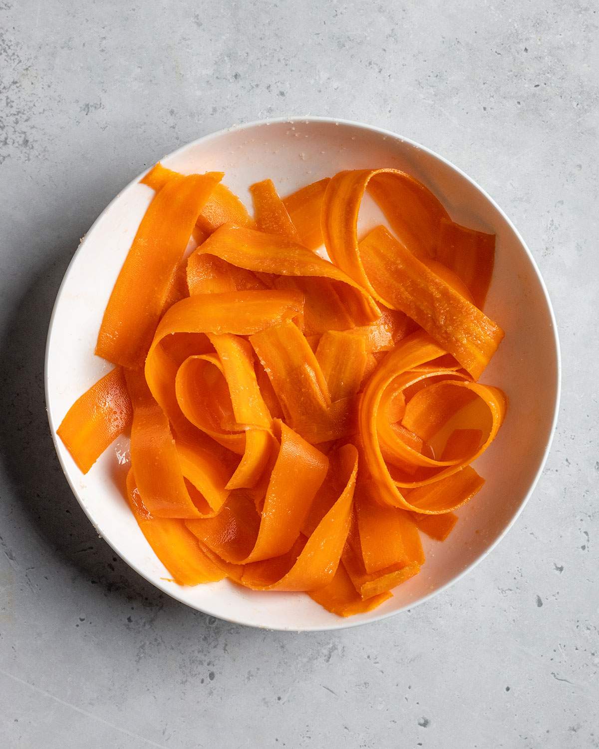 carrots softening with salt in a bowl