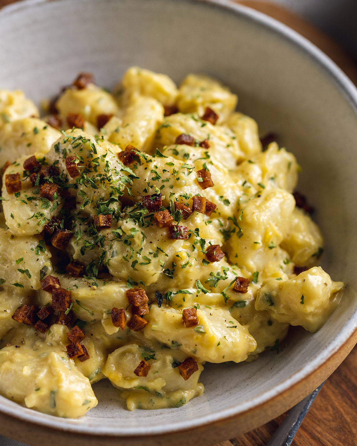 gnocchi carbonara in a white bowl