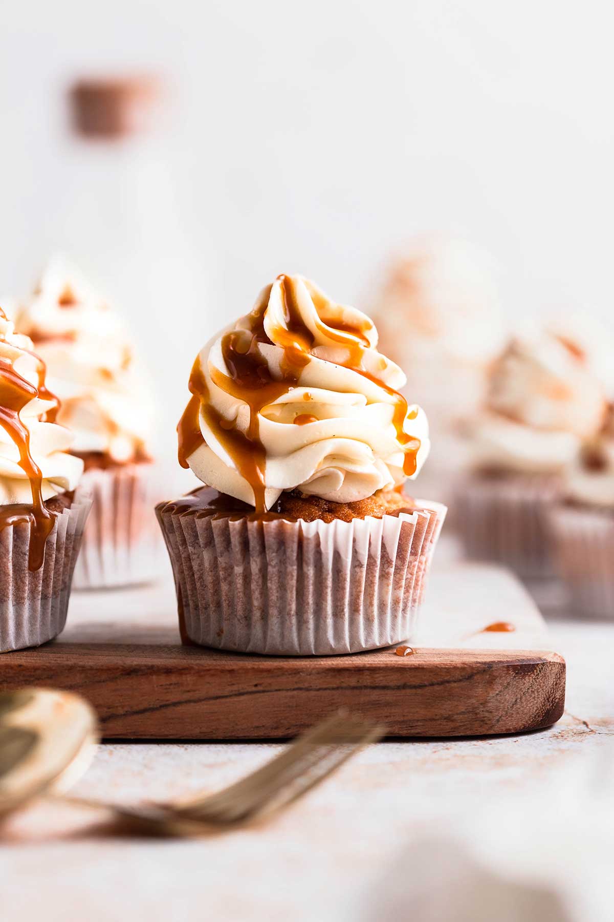 a delicious vegan banoffee cupcake on a wooden serving board