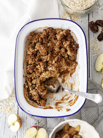 vegan breakfast crumble in a rectangular oven dish with a spoon on the side