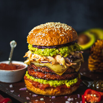 vegan burger with homemade vegan burger buns sitting on a black table