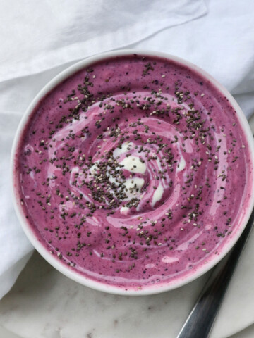 pink vegan keto breakfast bowl on a white table with a tablecloth on the side