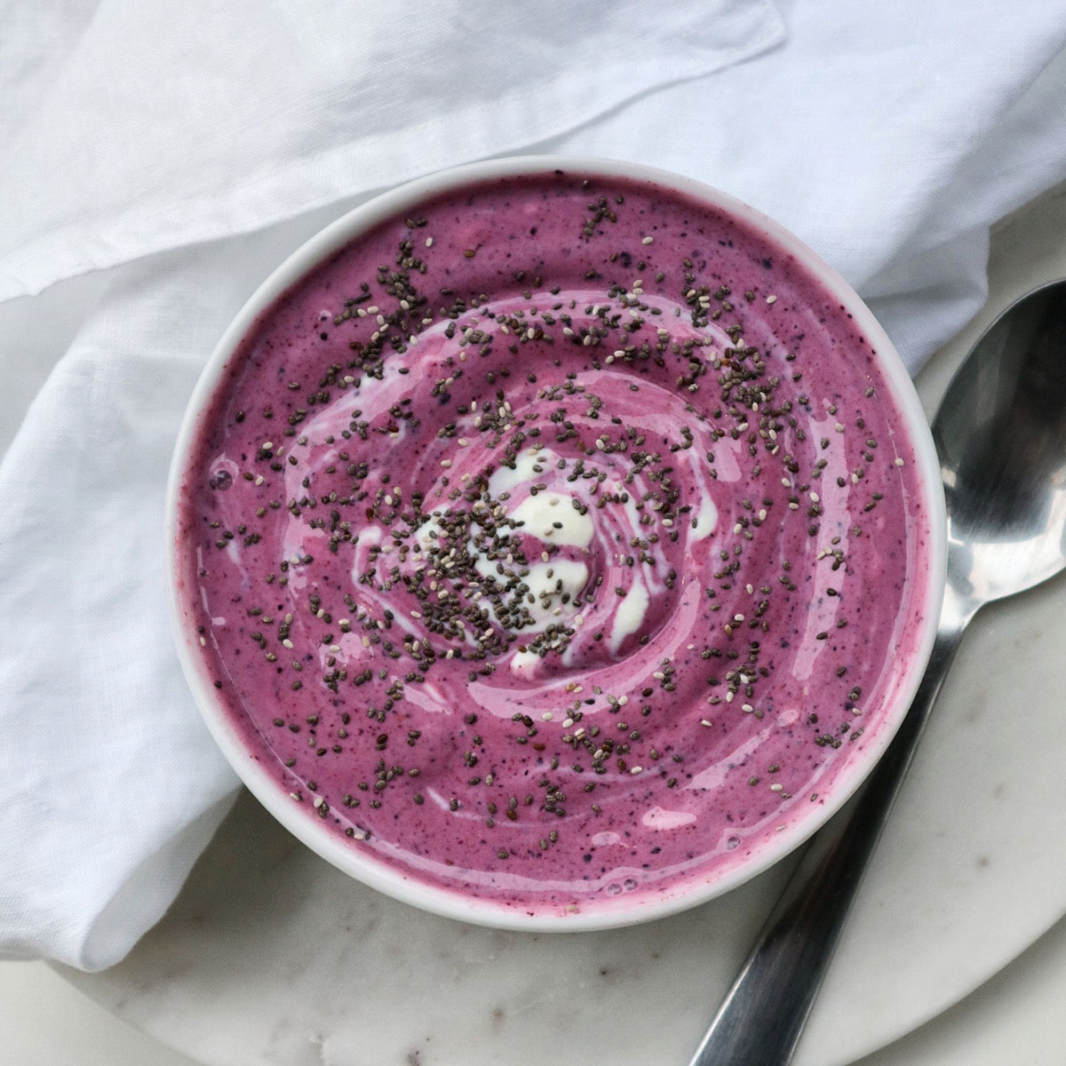 pink vegan keto breakfast bowl on a white table with a tablecloth on the side