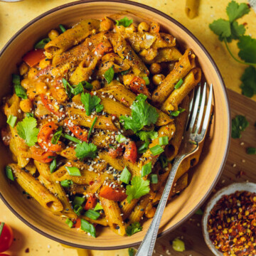 A yellow bowl with vegan one pot curry noodles