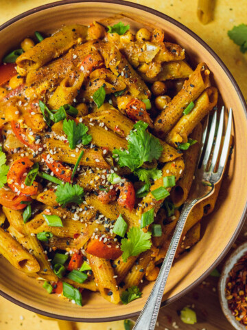 A yellow bowl with vegan one pot curry noodles