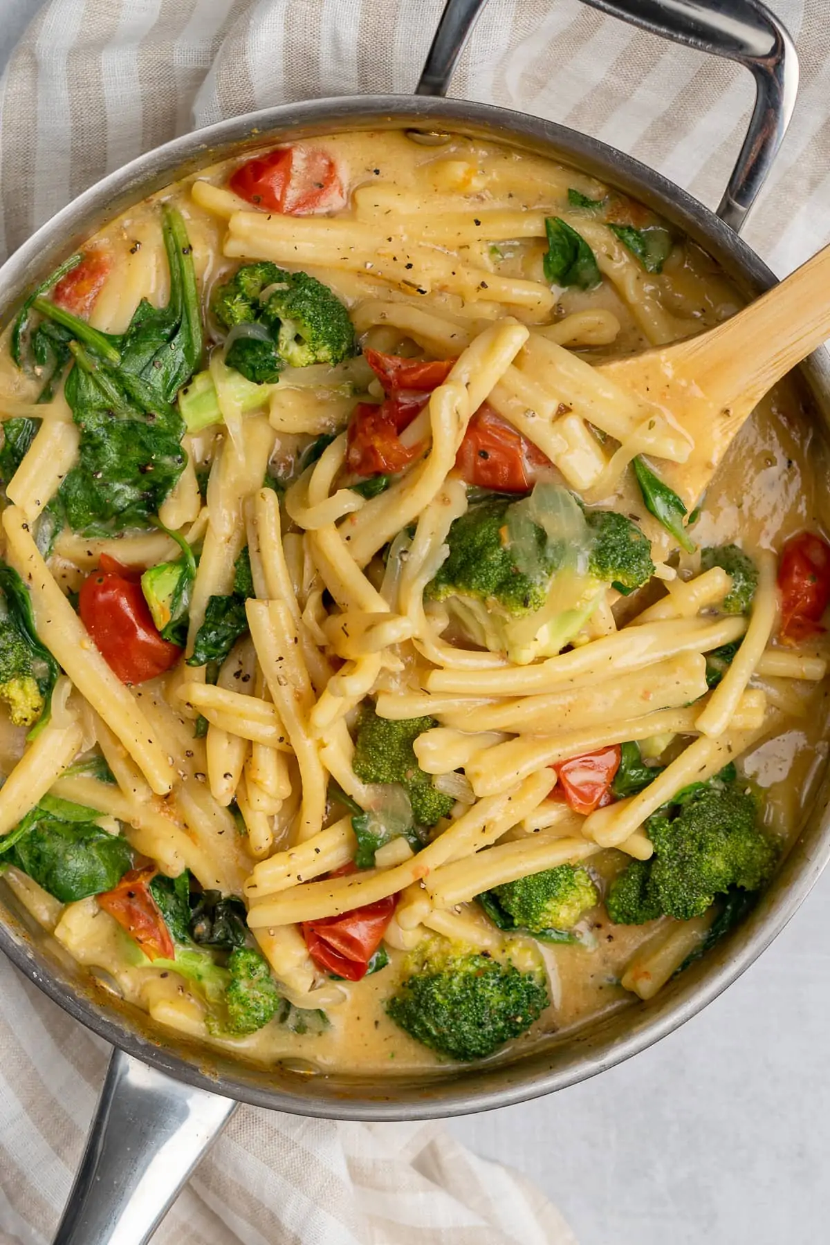 a saucepan on a white table filled with a vegan one pot pasta