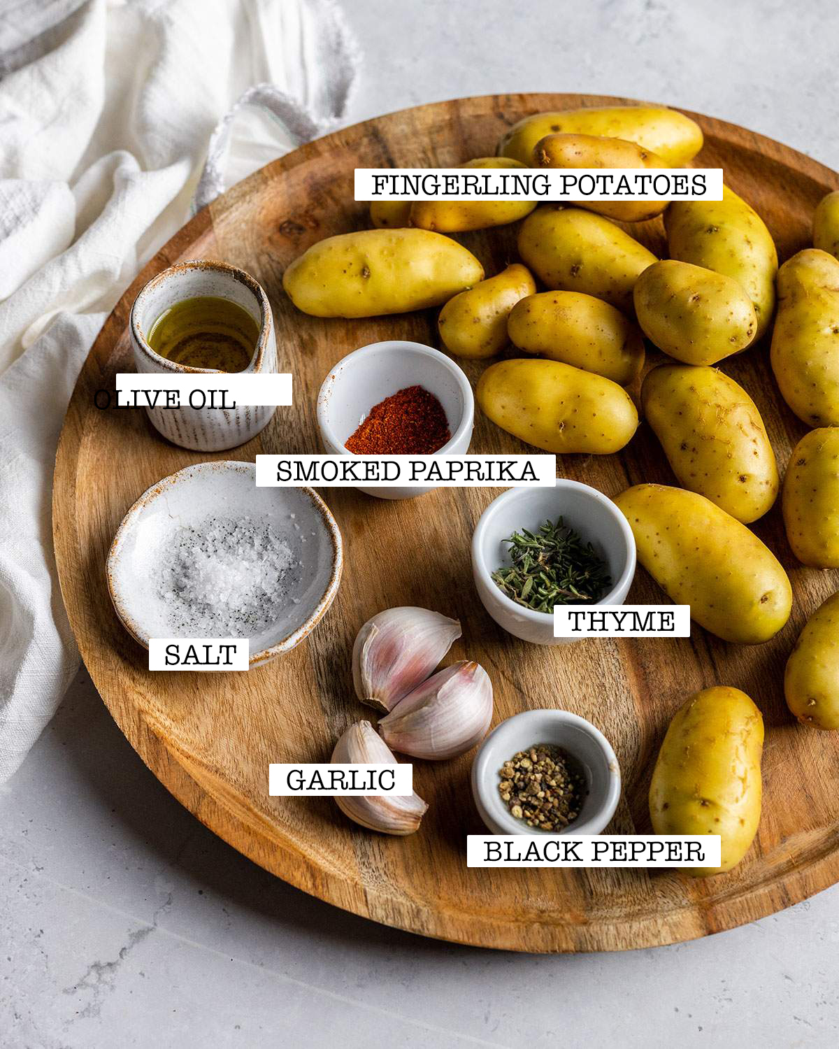 ingredients for air fryer fingerling potatoes on a wooden board