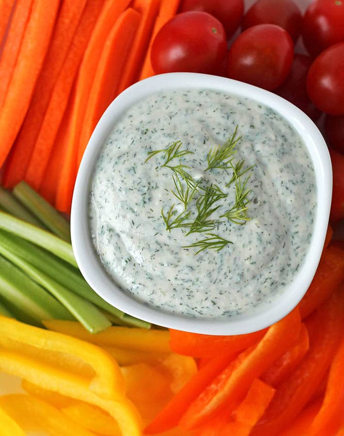 A white bowl filled with creamy vegan dip. The dip is made with a protein-rich silken tofu, providing a delicious and healthy dip for veggies.