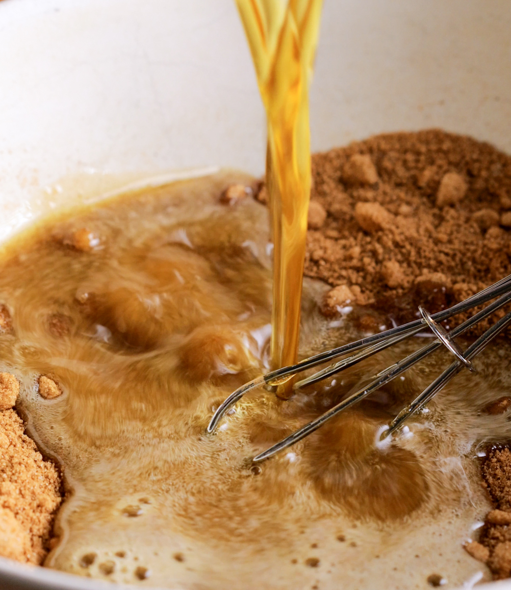 pouring melted butter onto cinnamon and sugar