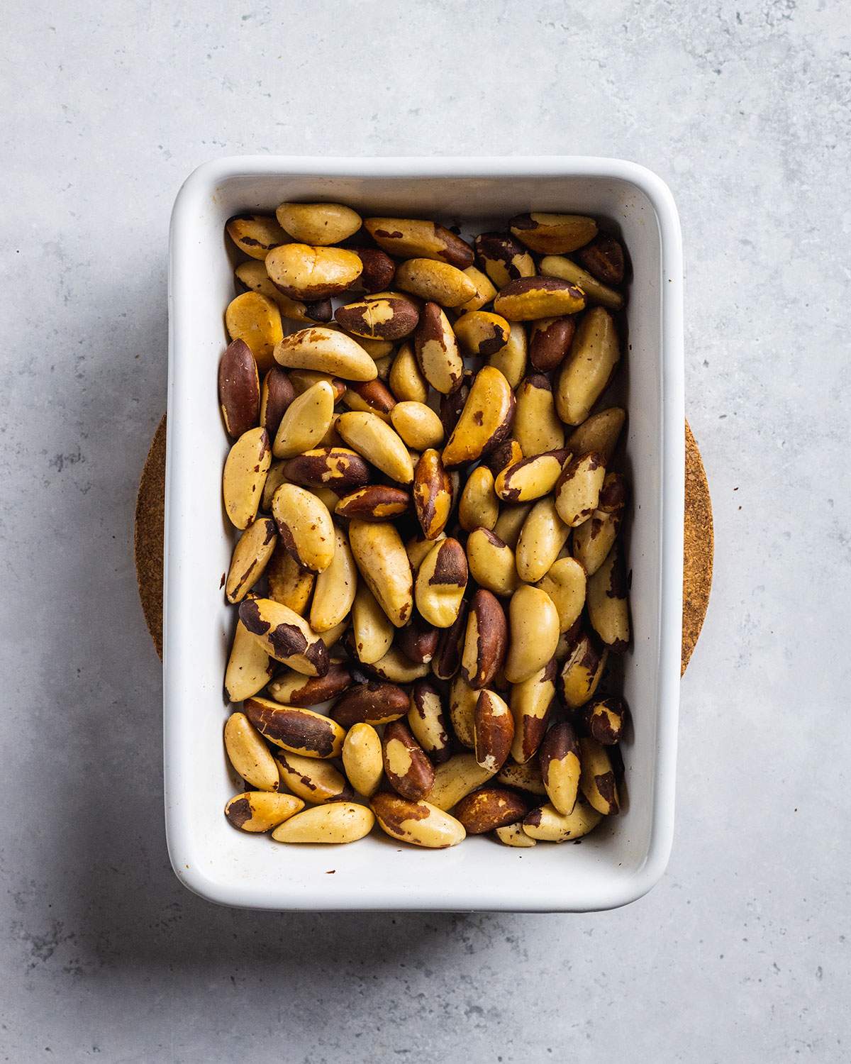 roasted brazil nuts in a white oven dish