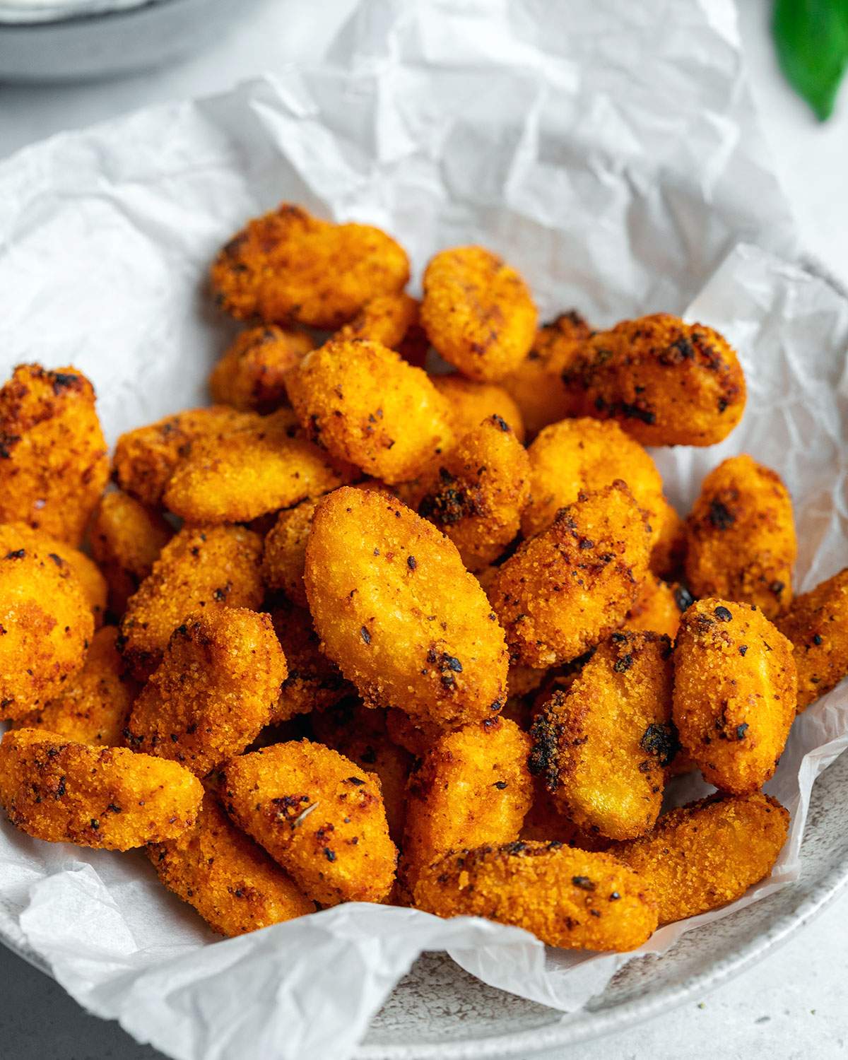 A bowl full of air fried gnocchi looking crunchy and delicious.