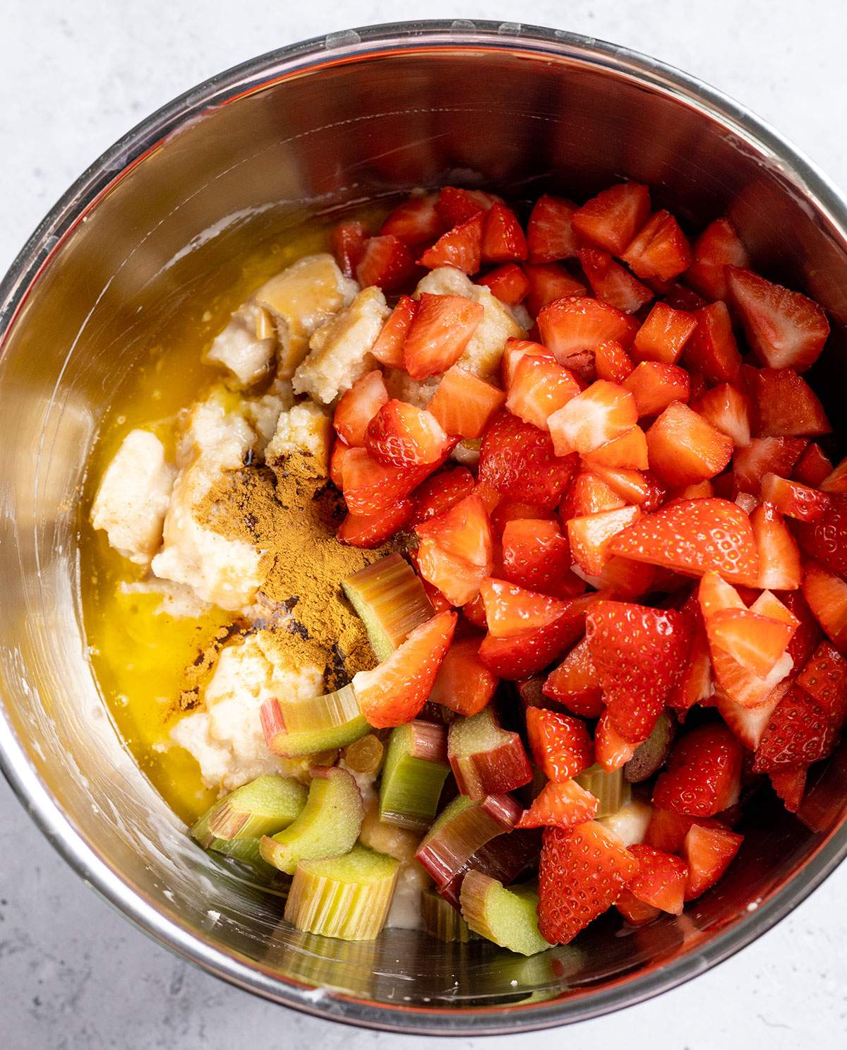 Ingredients for vegan bread pudding in a large bowl before mixing.