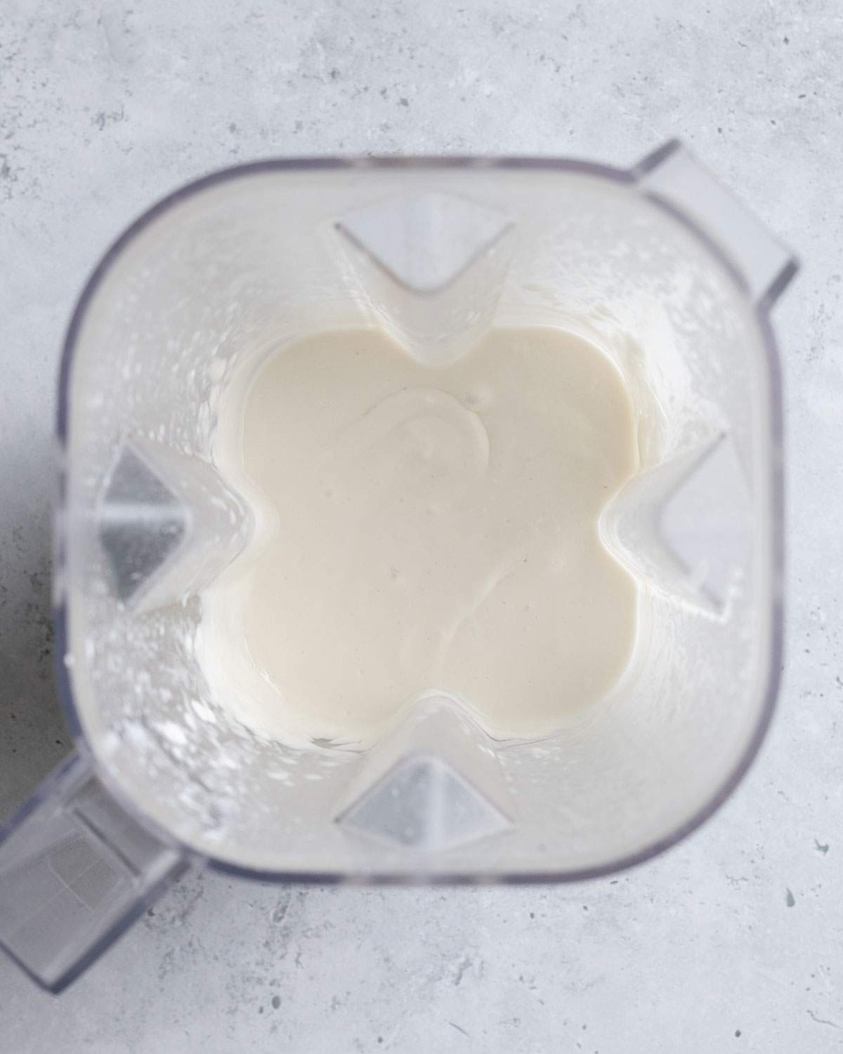 Vegan feta cheese mix has been blended and can be seen from the top in a blender.