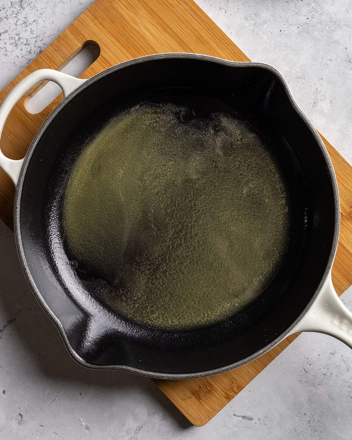 Melted vegan butter and sugar are shown in a cast iron skillet.