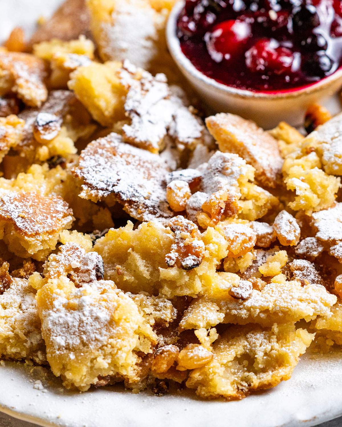 Vegan Kaiserschmarrn is shown up close with a dusting of powdered sugar.